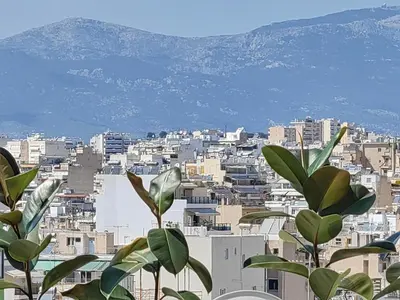a view of a city with buildings and a plant at Lycabettus Vista Luxury Suite in Athens