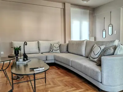 a living room with a couch and a table at Lycabettus Vista Luxury Suite in Athens