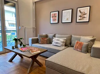 a living room with a couch and a table at AgiasFoteinis20 in Athens