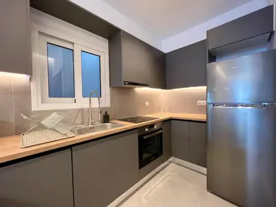 a kitchen with a stainless steel refrigerator and a sink at AgiasFoteinis20 in Athens