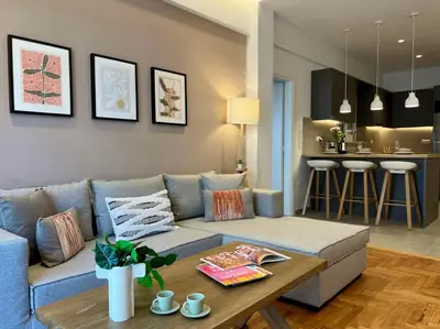 a living room with a couch and a table at AgiasFoteinis20 in Athens