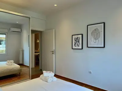 a bedroom with a bed and a mirror at AgiasFoteinis20 in Athens