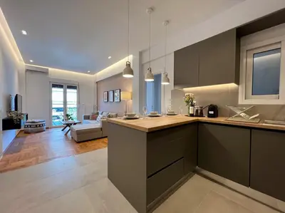 a kitchen with a counter and a living room at AgiasFoteinis20 in Athens