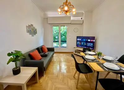 a living room with a couch and a table at New City Apartment Neos Kosmos in Athens