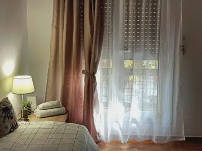 a bedroom with a bed and a window at New City Apartment Neos Kosmos in Athens