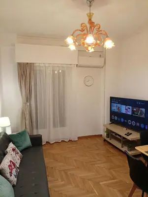 a living room with a couch and a television at New City Apartment Neos Kosmos in Athens