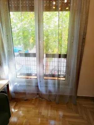 a room with two large windows and a wooden floor at New City Apartment Neos Kosmos in Athens