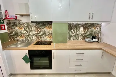 a kitchen with white cabinets and a sink at New City Apartment Neos Kosmos in Athens