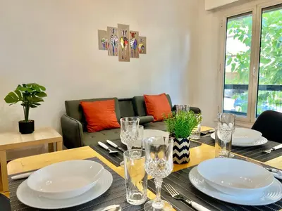 a dining room with a table with plates and glasses at New City Apartment Neos Kosmos in Athens