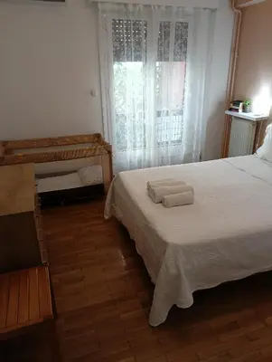 a bedroom with a bed with two towels on it at New City Apartment Neos Kosmos in Athens
