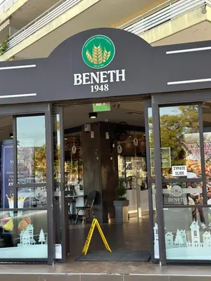 a store with a sign on the front of it at Athens Sea Front Apartment, Varkiza in Varkiza