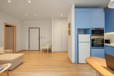 a kitchen and living room with blue and white appliances at Athens Sea Front Apartment, Varkiza in Varkiza