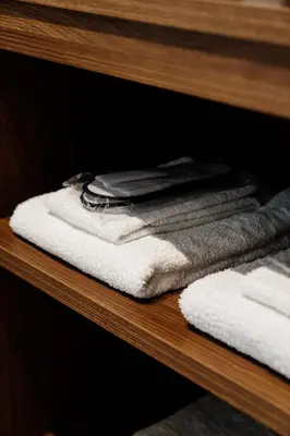 a shelf with towels and towels on it at Athens Sea Front Apartment, Varkiza in Varkiza