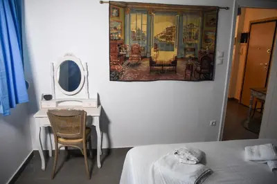 a bedroom with a table and a mirror and a bed at Velvet new apt in Ilissia in Athens