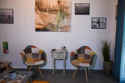 a living room with two chairs and a table at Velvet new apt in Ilissia in Athens