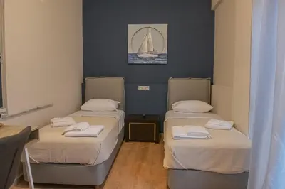 two beds in a room with a sail on the wall at Urban Oasis, Stylish Short Stay Apartment in Piraeus Center in Piraeus