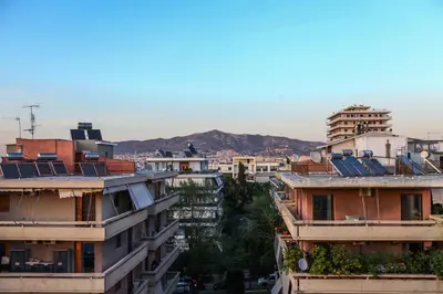 a group of buildings with mountains in the background at Loft condo next to metro station. Amazing view! in Athens