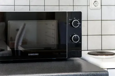 a microwave oven sitting on top of a counter at Loft condo next to metro station. Amazing view! in Athens