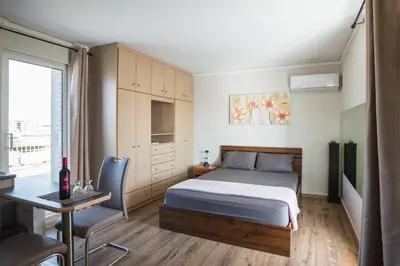 a bedroom with a bed and a desk and a deskablish at Loft condo next to metro station. Amazing view! in Athens
