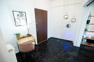 a room with a chair and a desk and a door at Love Travel Athens Apartments in Athens