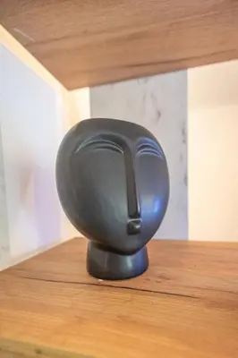 a black object sitting on top of a wooden table at Love Travel Athens Apartments in Athens