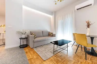 a living room with a couch and a table at Phaedrus Living: Luxury Flat Panormou in Athens