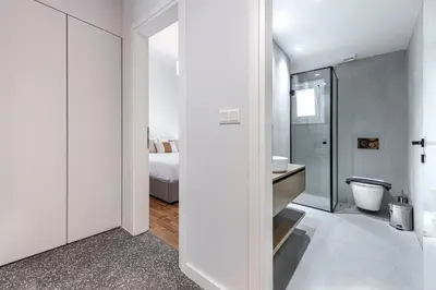 a white bathroom with a sink and a toilet at Phaedrus Living: Luxury Flat Panormou in Athens