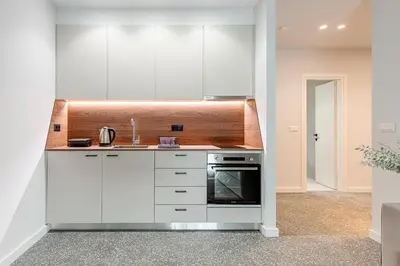 a kitchen with white cabinets and a stove at Phaedrus Living: Luxury Flat Panormou in Athens