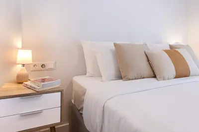 a bedroom with two beds and a table with a lamp at Phaedrus Living: Luxury Flat Panormou in Athens