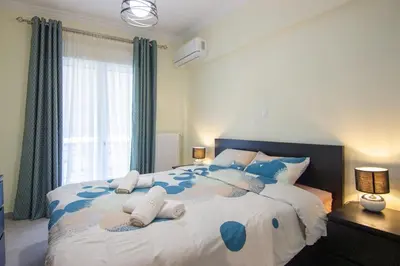 a bedroom with a large bed with towels on it at Luxury quiet apartment near Metro in Athens