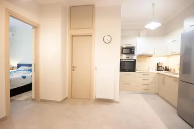a kitchen with a door leading to a bedroom at Luxury quiet apartment near Metro in Athens