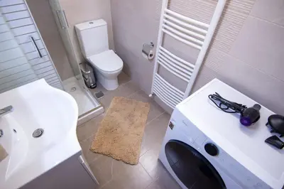 a bathroom with a white sink and a toilet at Luxury quiet apartment near Metro in Athens