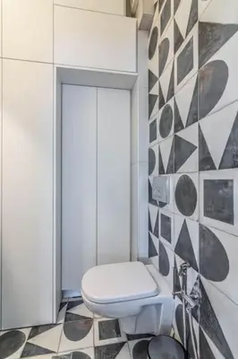 a bathroom with a toilet and a tile wall at Light in Athens
