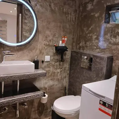 a bathroom with a toilet and a sink and a mirror at Boutique Eptalofos 15min from airport and sea in Kouvarás