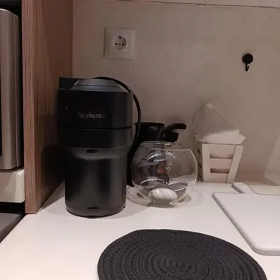 a coffee maker on a counter next to a bowl of food at Boutique Eptalofos 15min from airport and sea in Kouvarás