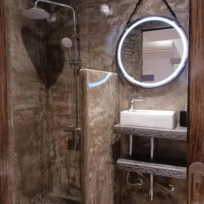 a bathroom with a sink and a mirror at Boutique Eptalofos 15min from airport and sea in Kouvarás