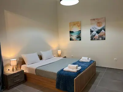 a bedroom with a bed with two towels on it at Spacious and beautiful house in Piraeus
