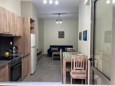 a kitchen with a table and a dining room at Spacious and beautiful house in Piraeus