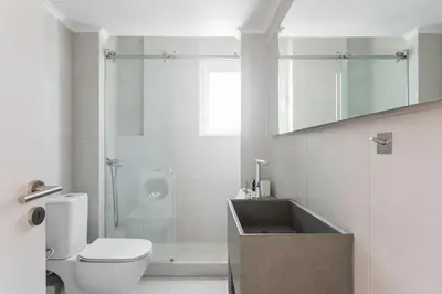 a bathroom with a sink and a toilet and a shower at Breezy 2BR Apartment by Marina Flisvos by UPSTREET in Athens