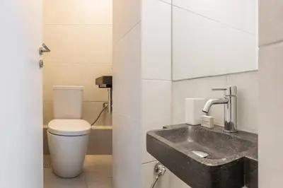 a bathroom with a sink and a toilet at Breezy 2BR Apartment by Marina Flisvos by UPSTREET in Athens