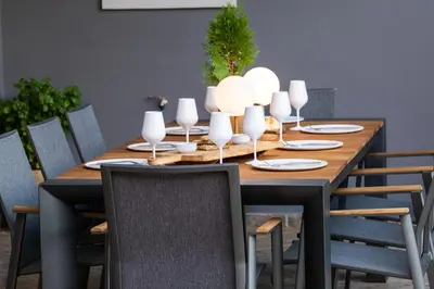a dining room table with chairs and a table with wine glasses at Casa Del G in Metókhi