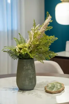 a vase with flowers in it on a table at Casa Del G in Metókhi