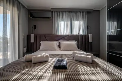 a bedroom with a large bed with two pillows at Casa Del G in Metókhi