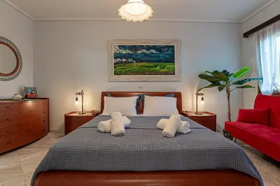 a bedroom with a bed with two towels at Feliz Apt- Breathtaking Seaview and Sunset by ΜΡS in Anavissos