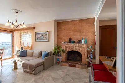 a living room with a couch and a fireplace at Feliz Apt- Breathtaking Seaview and Sunset by ΜΡS in Anavissos