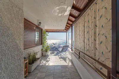 a balcony with chairs and a view of the ocean at Feliz Apt- Breathtaking Seaview and Sunset by ΜΡS in Anavissos