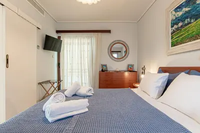 a bedroom with a bed with towels on it at Feliz Apt- Breathtaking Seaview and Sunset by ΜΡS in Anavissos