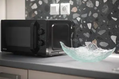 a bowl on a counter next to a microwave at New Spacious & Stylist Apt in Piraeus