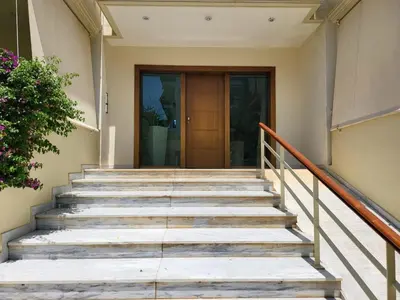 a set of stairs leading to a door at Luxe Apartment in Central Glyfada in Athens