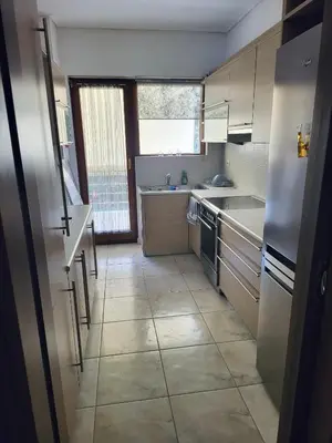 a kitchen with a refrigerator and a sink at Luxe Apartment in Central Glyfada in Athens